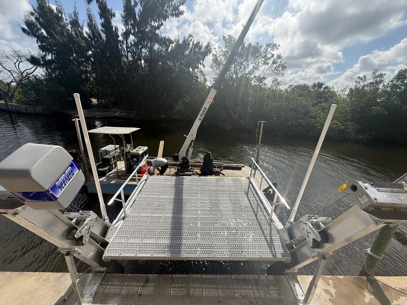 CC Docks and Lifts crew working from a barge in a canal