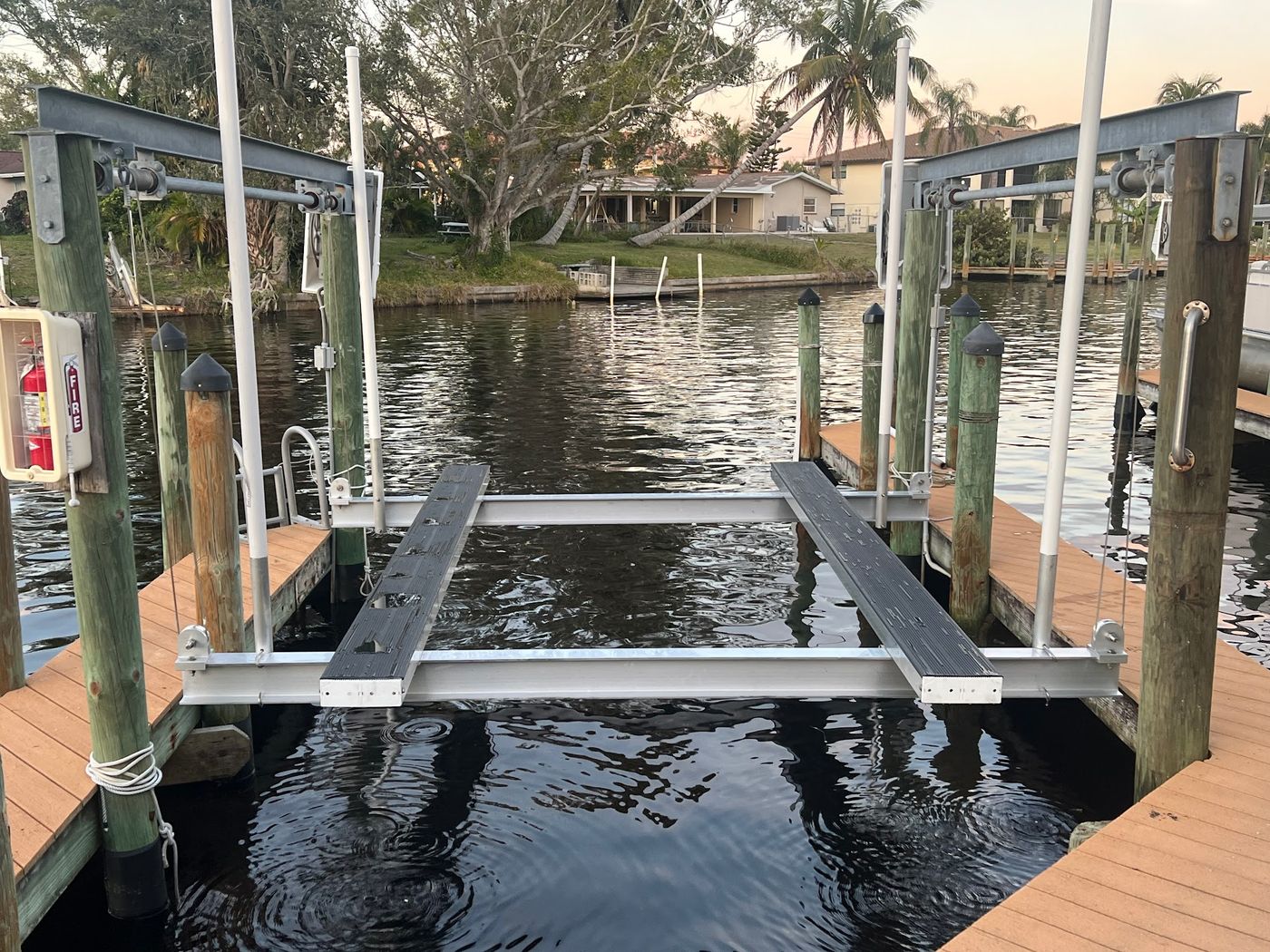 New boat lift cradle installed between dock pilings