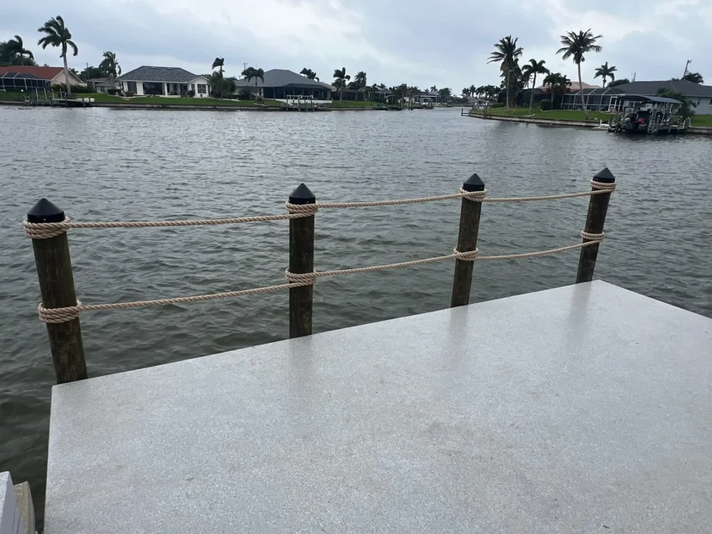 Waterfront composite dock platform with rope railing and open water view